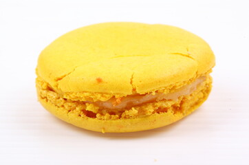 Yellow macaron isolated in white background