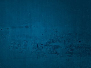 old ripped torn posters textures on blue cement wall use as background. grunge creased crumpled paper vintage collage placards on weathered concrete wall with empty space for text.