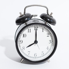 black vintage style alarm clock isolated on a white background