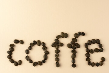 The word coffee is laid out from a grain of black coffee, with a place for the inscription.