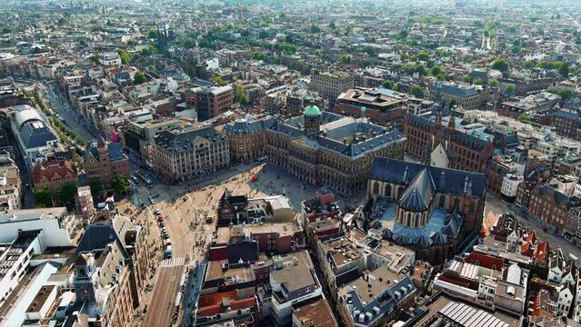 Aerial view of Amsterdam, Netherlands. Flying over the rooftops around Amsterdam Royal Palace (Koninklijk Paleis) and The New Church (De Nieuwe Kerk) at Dam Square in the centre of Amsterdam