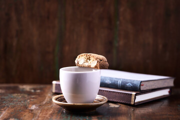 Cantuccini (Italian cookie) and a Cup of coffee on dark wooden background. Copy space	