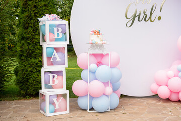 transparent cubes with balls and inscription baby for gender party
