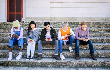 Fototapeta premium Best friends group of millennial people using mobile smart phone together