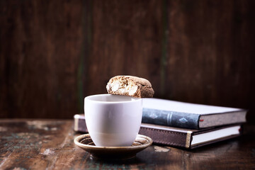Cantuccini (Italian cookie) and a Cup of coffee on dark wooden background. Copy space	