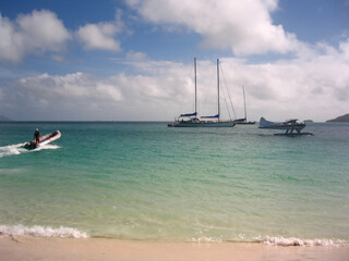 Several boats and a seaplane on the beach in the Whitsunday Islands in Australia
