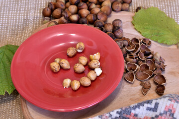 Hazelnut kernels on a plate and the shell lies on the board.