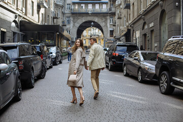 A couple in love walks in the autumn city in light clothes