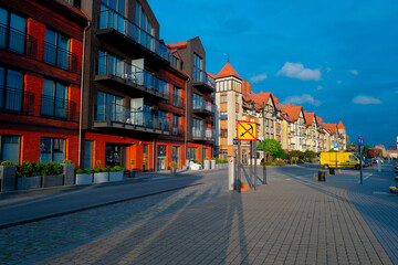 2022-06-02 houses on the embankment of the slupia river on the sunset. baltic sea, ustka, poland