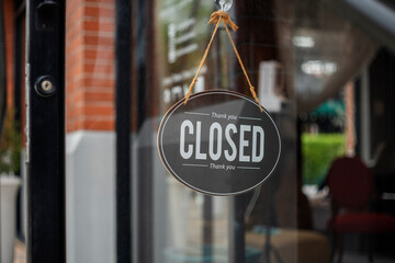 closed sign hanging outside a restaurant, store, office or other