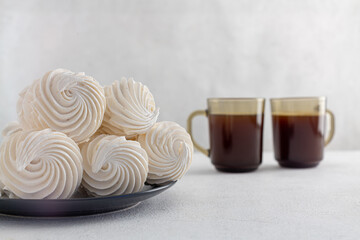 delicious zephyr on a plate standing on a light marble background. homemade desserts, pastry shop, pastry chef, holiday, birthday, valentine's day, confectionery products, tea party concept