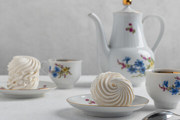 delicious zephyr on a plate standing on a light marble background. homemade desserts, pastry shop, pastry chef, holiday, birthday, valentine's day, confectionery products, tea party concept