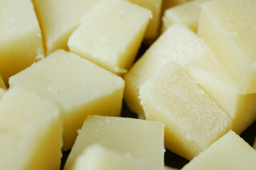 close up of cube shape fresh cheese on in a bowl 