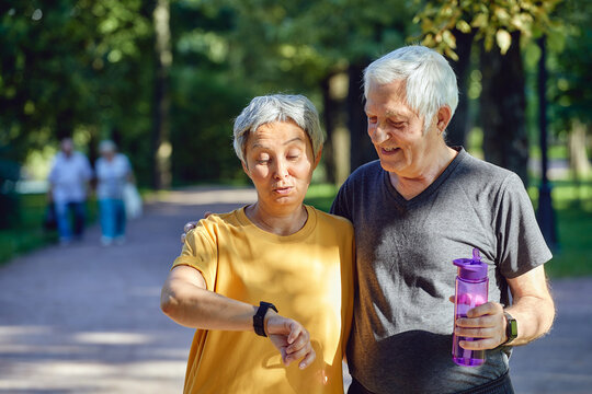 Older Active Couple Outdoors With Modern Tech