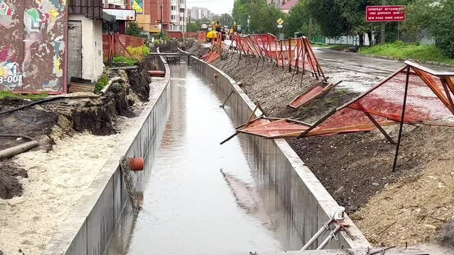 Repair and upgrade of the drainage system underground in the city. Overpass repair on the city street. Drainage system in rainy weather. Road repair and laying of new engineering and technical communi