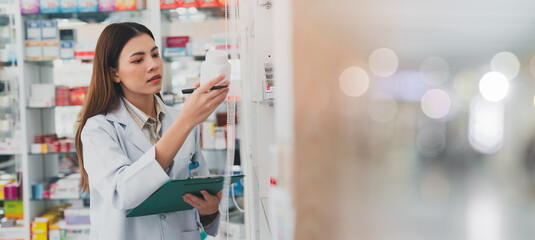 female pharmacist at drugstore.Doctors specializing in medicines.Medical product inventory.female doctor holding a prescription.Health care pharmacists work at the hospital. - obrazy, fototapety, plakaty