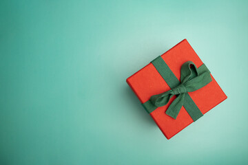 christmas gift wrapping,red present box on green background