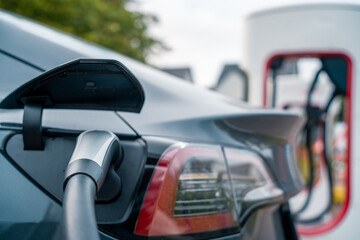 An Electric EV car plugging in and recharging