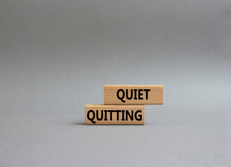 Quiet quitting symbol. Concept word Quiet quitting on wooden blocks. Beautiful grey background....