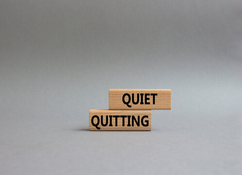 Quiet Quitting Symbol. Concept Word Quiet Quitting On Wooden Blocks. Beautiful Grey Background. Business And Quiet Quitting Concept. Copy Space.