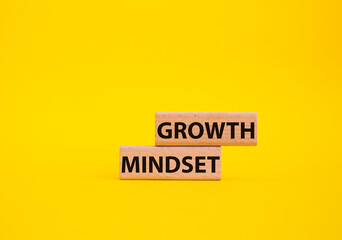 Growth Mindset symbol. Concept word Growth Mindset on wooden blocks. Beautiful yellow background. Business and Growth Mindset concept. Copy space