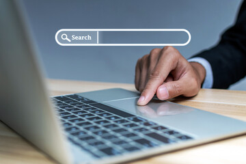 businessman hand touching on mobile laptop computer with virtual screen search button, searching...