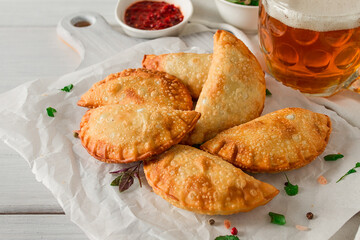 Fried chebureks, close-up, on a light background, no people,