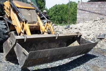 Modern excavator running on the road