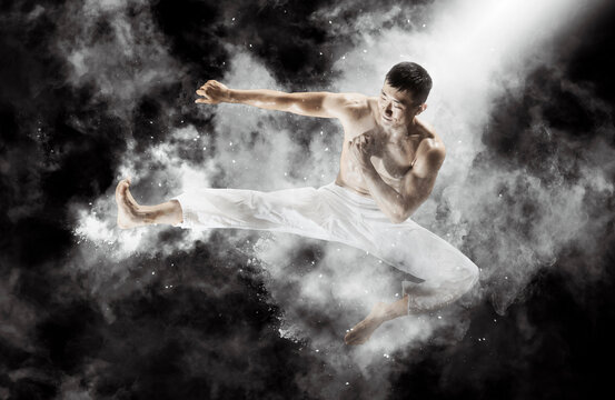 Martial arts masters. Smoke background © Andrey Burmakin