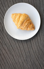 Fresh delicious breakfast morning with Coffee, food croissants on brunch plate, jam on dark grunge wooden background. continental breakfast captured on above table top view flat lay.