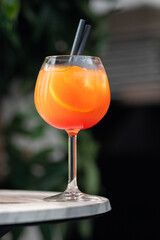 Glass of ice cold Aperol spritz cocktail served in a wine glass