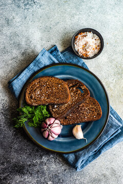 Overhead view of toasted rye bread with garlic and sea salt