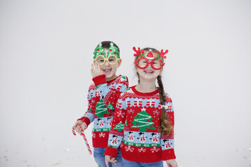 Preschool boy, girl in Christmas sweaters