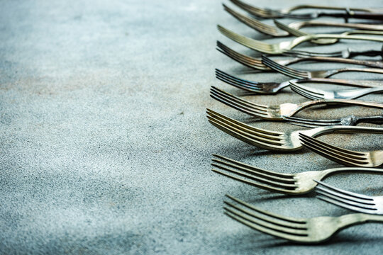 Close-Up of a row of assorted vintage forks on a table