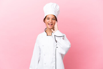Little caucasian chef girl isolated on pink background shouting with mouth wide open