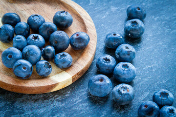 Blueberries on a wooden table. Fresh berries. Wild blueberries on a wooden stand