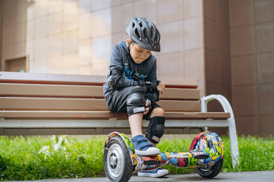 boy goes in for sport learning to ride a hoverboard.or gyro scooter