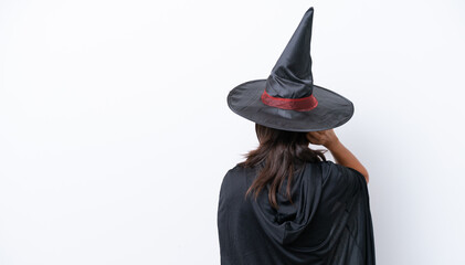 Young hispanic woman dressed as witch over isolated background in back position and thinking