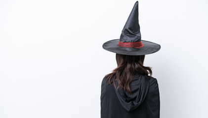 Young hispanic woman dressed as witch over isolated background in back position