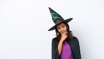 Young hispanic woman dressed as witch over isolated background having doubts