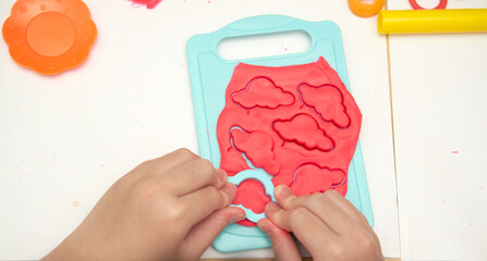 kid play play dough with block print