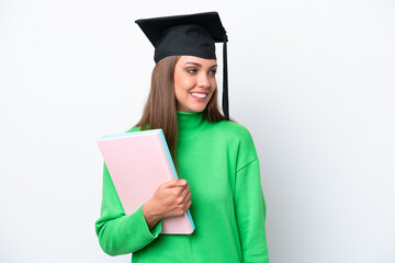 Young student caucasian woman isolated on white background looking to the side and smiling