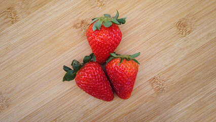 Strawberries isolated on a wood background