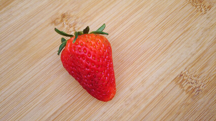 Strawberry isolated on a wood background
