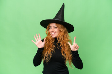 Young caucasian woman costume as witch isolated on green screen chroma key background counting seven with fingers