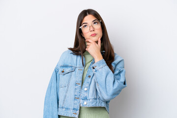 Young Brazilian woman isolated on white background having doubts