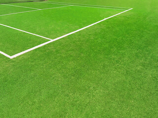 Obraz premium Tennis court with green grass and markings outdoors