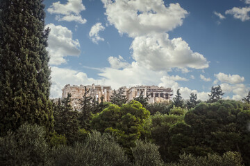 Fototapeta na wymiar View of Parthenon over trees - View from Plaka with evergreen framing picture - Room for copy