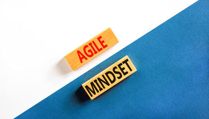 Agile mindset symbol. Concept words Agile mindset on wooden blocks. Beautiful white and blue background. White and blue paper. Business flexible and agile mindset concept. Copy space.