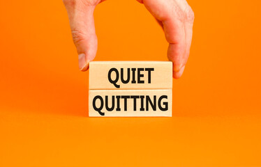 Quiet quitting symbol. Concept words Quiet quitting on wooden blocks. Beautiful orange table orange...